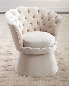 a white chair sitting on top of a carpeted floor