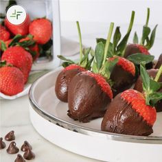 chocolate covered strawberries sit on a plate