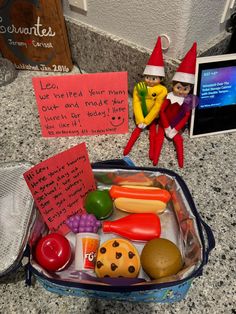 two elfs are sitting next to each other on the counter