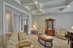 a living room filled with furniture and a piano