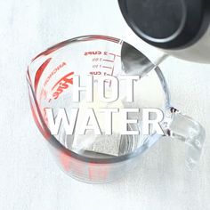 a blender is pouring red liquid into a measuring cup with the words hot water on it