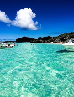 several boats floating in the clear blue water