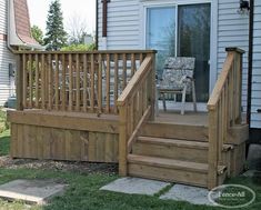 a wooden deck with steps leading up to the front door