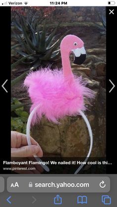 a pink flamingo headband with a black and white bird on it's forehead