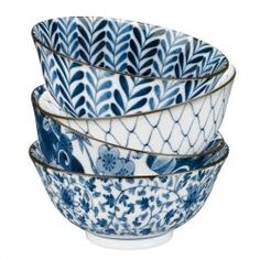 four blue and white bowls stacked on top of each other