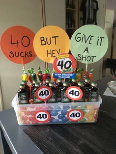 a table topped with lots of bottles of beer next to balloons that say it's 40