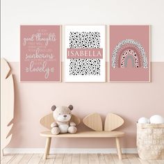 a pink wall with two pictures on it and a teddy bear sitting on a bench