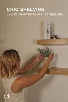 a woman placing flowers on shelves in a living room with the text chic shelving