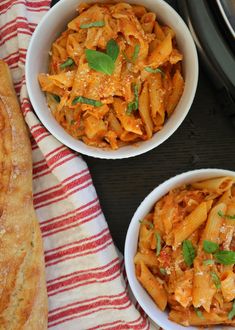 three bowls filled with pasta on top of a table