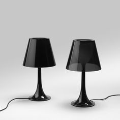 two black lamps sitting next to each other