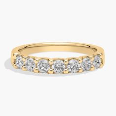 a yellow gold wedding band with five diamonds