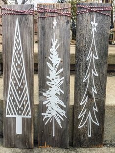 three wooden christmas trees painted on them