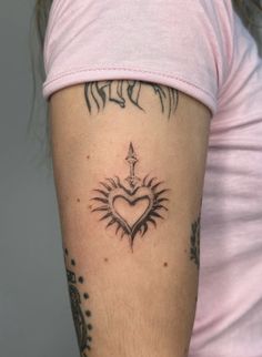 a woman with a heart tattoo on her arm