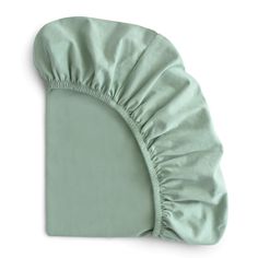 a green pillow with a ruffled edge on the top and bottom of it's cover