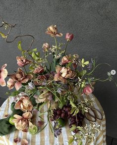 a bunch of flowers sitting on top of a table