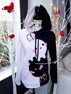 My original design, BunyingBunyang, as unisex hoodie. The hoodie has a soft outside with a vibrant print, and an even softer brushed fleece inside. The hoodie has a relaxed fit. * 70% polyester, 27% cotton, 3% elastane * Fabric weight: 8.85 oz/yd² (300 g/m²) * Soft cotton-feel fabric face * Brushed fleece fabric inside * Double-lined hood with design on both sides * Unisex style * Overlock seams * Comes with drawstrings