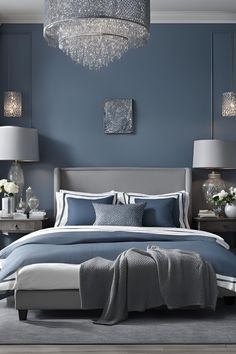 a bedroom with blue walls and white furniture in the center, along with chandelier