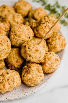 a white plate topped with meatballs and skewers