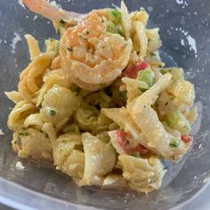 a plastic container filled with pasta and shrimp