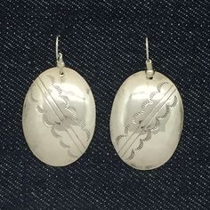 "Vintage Navajo dangle earrings. They were formerly post earrings and converted to pierced dangles with ear wires. The earrings are large oval disks that were hand crafted and stamped by Navajo artisan D Vandever. Their full length is 1 7/8\" and the dangle portion 1 1/4\" x 7/8\". They weigh 6.2 grams and are stamped sterling D Vandever. The earrings are in good vintage condition with a nice luster and shine to them. They have some signs of age and wear. Items come in a brightly colored paper b Stamped Dangle Jewelry, Artisan Oval Earrings For Pierced Ears, Artisan Etched Dangle Earrings, Artisan Etched Drop Earrings, Handmade Southwestern Drop Earrings, Vintage Etched Dangle Jewelry, Southwestern Style Drop Earrings As Gift, Etched Sterling Silver Dangle Earrings, Southwestern Style Drop Earrings