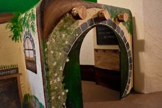 an arch made out of wood and painted green