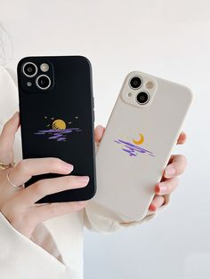 a woman holding up her phone case with the sun and moon stickers on it