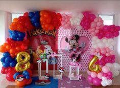 a room decorated with balloons and mickey mouse decorations