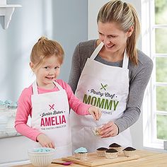 a mother and daughter preparing cupcakes in the kitchen