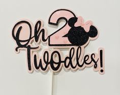 a pink and black cake topper with the number two on it