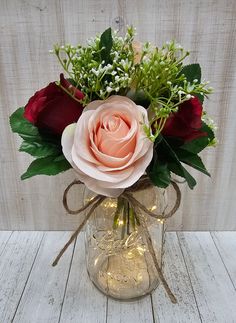 a vase filled with flowers on top of a wooden table