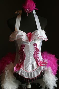 a white corset with pink and white feathers