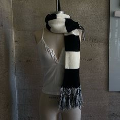 a mannequin wearing a black and white scarf