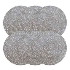 six round placemats in silver with white dots on the top and bottom, set of