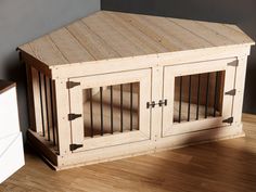 a dog house made out of wood with bars on the top and bottom doors open