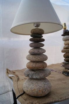 a lamp sitting on top of a table next to rocks