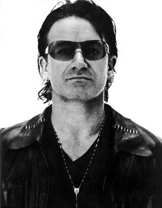 a man wearing sunglasses and a leather jacket with a quote from bonro on it