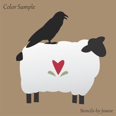 two black birds sitting on top of a white sheep's head with a heart painted on it