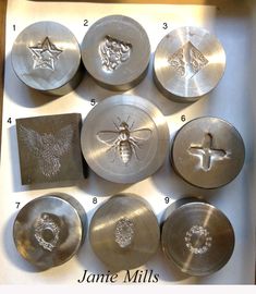 some metal plates with designs on them in a box and instructions for how to use them