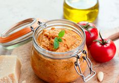 a jar filled with food sitting on top of a wooden cutting board