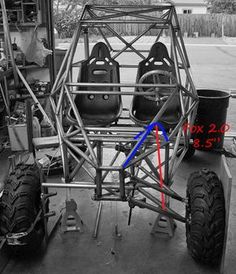 the rear end of a vehicle with four tires and two seats on it, in black and white