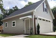 a gray house with white trim and windows