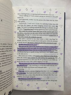 an open book with purple writing on the page and inside pages are black and white