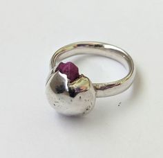 Molten metal raw ruby blob ring. Unisex design. AU/UK size O, US size  7.5, EU 55.3 This ring is made from molten sterling silver  and cast in sand encasing a raw ruby, the set on an oval sterling silver band. This is a very modern artistic piece that is one of a kind.  Imprints of the sand from this casting method are left in silver, adding to the rustic finish and creating an natural organic texture.   The ring band is 2mm thick and 4mm wide. the oval shape makes it very comfortable to wear. The raw ruby blob is 6.27 high, 12.81 in width and 14.79 length. I am in the business of taking time with each piece and enjoy the process of creating a special item that will be worn with pride.  Exchanges or returns will be accepted within 30 days of purchase. No refunds or exchanges will be provid Raw Ruby, Molten Metal, Enjoy The Process, Organic Style, Viking Style, Modern Ring, Metal Ring, Ruby Ring, Sterling Silver Bands