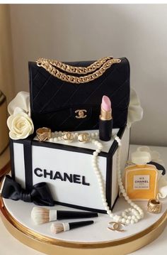 a cake made to look like a chanel bag with makeup and lipstick on it