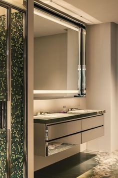 a bathroom with two sinks and a large mirror in it's center wall area