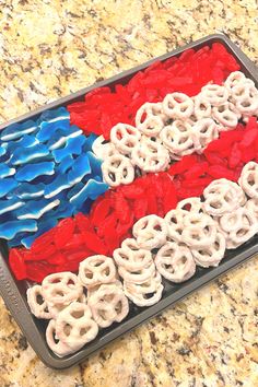 a tray filled with red, white and blue pretzels on top of a counter