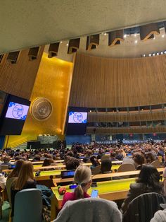 an auditorium filled with people sitting in chairs