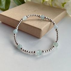 Add some subtle colour to your look with this Sterling Silver bracelet which features genuine Aquamarine accent beads. Wear it solo for a simple chic look or layer with others to create your unique bohemian stack! Aquamarine is a stone of courage. Its calming energies reduce stress and quiet the mind. It is said to invoke tolerance clarify perception, sharpen the intellect and clear confusion.  the birthstone of March, this aquamarine bracelet is a great gift for those with a March birthday. All Elegant Silver Beaded Bracelets For Birthday Gift, Silver Beaded Bracelet With Gemstone Beads As Gift, Silver Gemstone Bracelet For Birthday, Hand-strung Round Sterling Silver Bracelet Gift, Hand-strung Sterling Silver Bracelet With Round Beads As Gift, Silver Beaded Bracelet With Birthstone For Birthday, Silver Bracelets With Birthstone Round Beads, Silver Beaded Birthstone Bracelets For Birthday, Silver Beaded Birthstone Bracelet As Gift