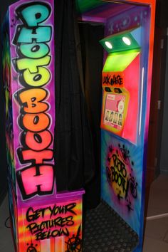 a brightly colored machine with graffiti on it's sides and lights above the door