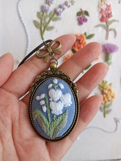 This locket - pendant is hand embroidered. Pendant size: 30x40mm/1.18x1.59in Chain length: 80cm/30in (default) The embroidery surface is protected from moisture and dirt with a professional impregnant. Every time I make embroidered jewelry, I put my heart and soul into it. For each embroidery, I spend a lot of time and prepare multiple projects. Even if the theme and project are the same, each sample is unique. Hand Embroidered Pendant, Blue Flower Necklace, Embroidered Pendant, Embroidered Jewelry, Gift Flower, Oval Pendant, Lily Of The Valley, Blue Flower, Memorial Gifts